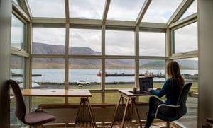 Woman sitting in her winter garden working from home