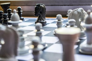 a close-up of a chessboard with black and white game pieces