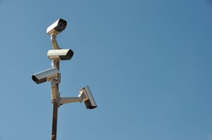 four surveillance cameras in front of the sky