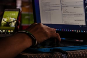 a close up of a hand working on a laptop